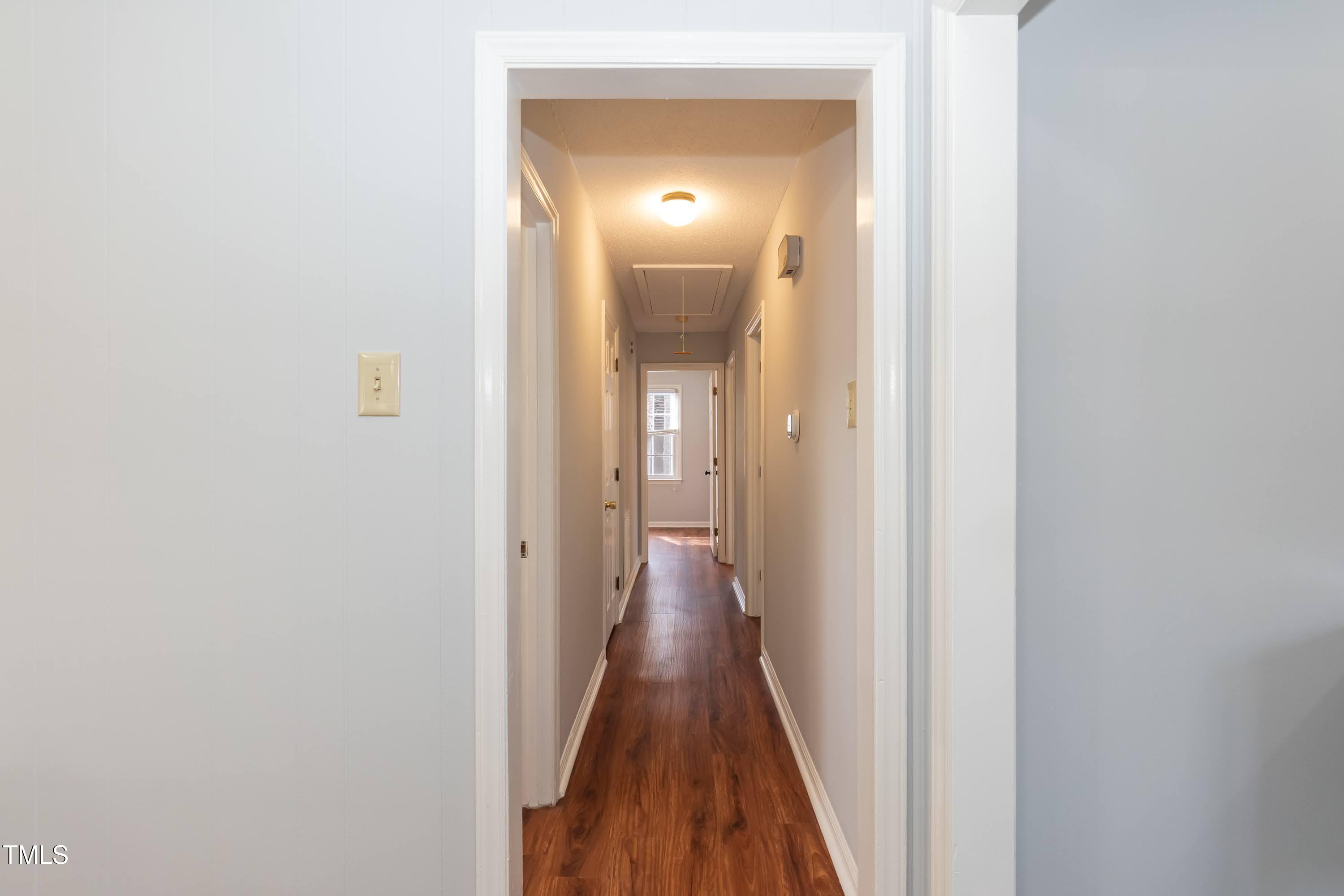 5604 Genesee Drive Durham, NC 27712 - Photo 22 of 45 a view of a hallway with wooden floor