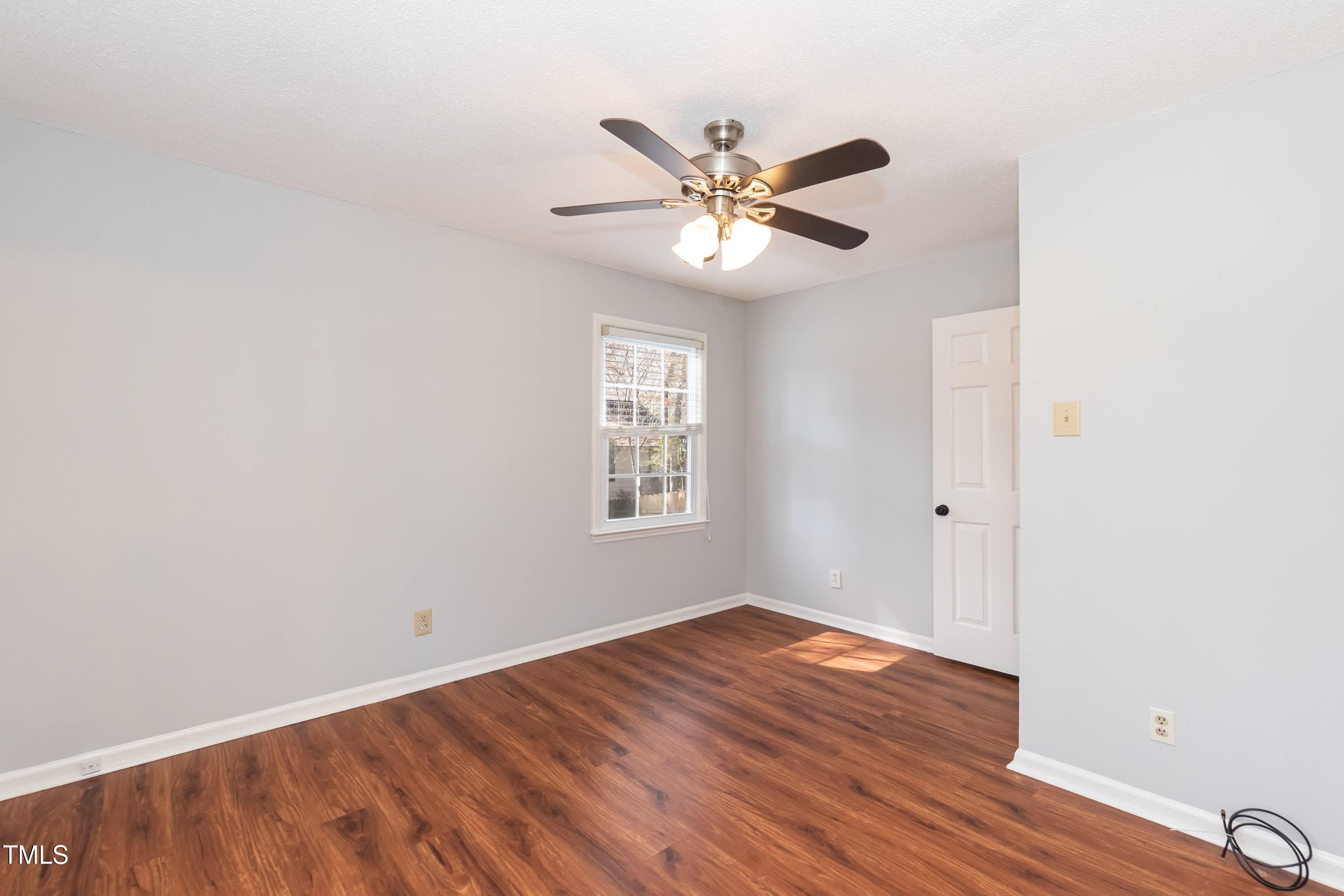 5604 Genesee Drive Durham, NC 27712 - Photo 25 of 45 a view of an empty room with wooden floor and a window