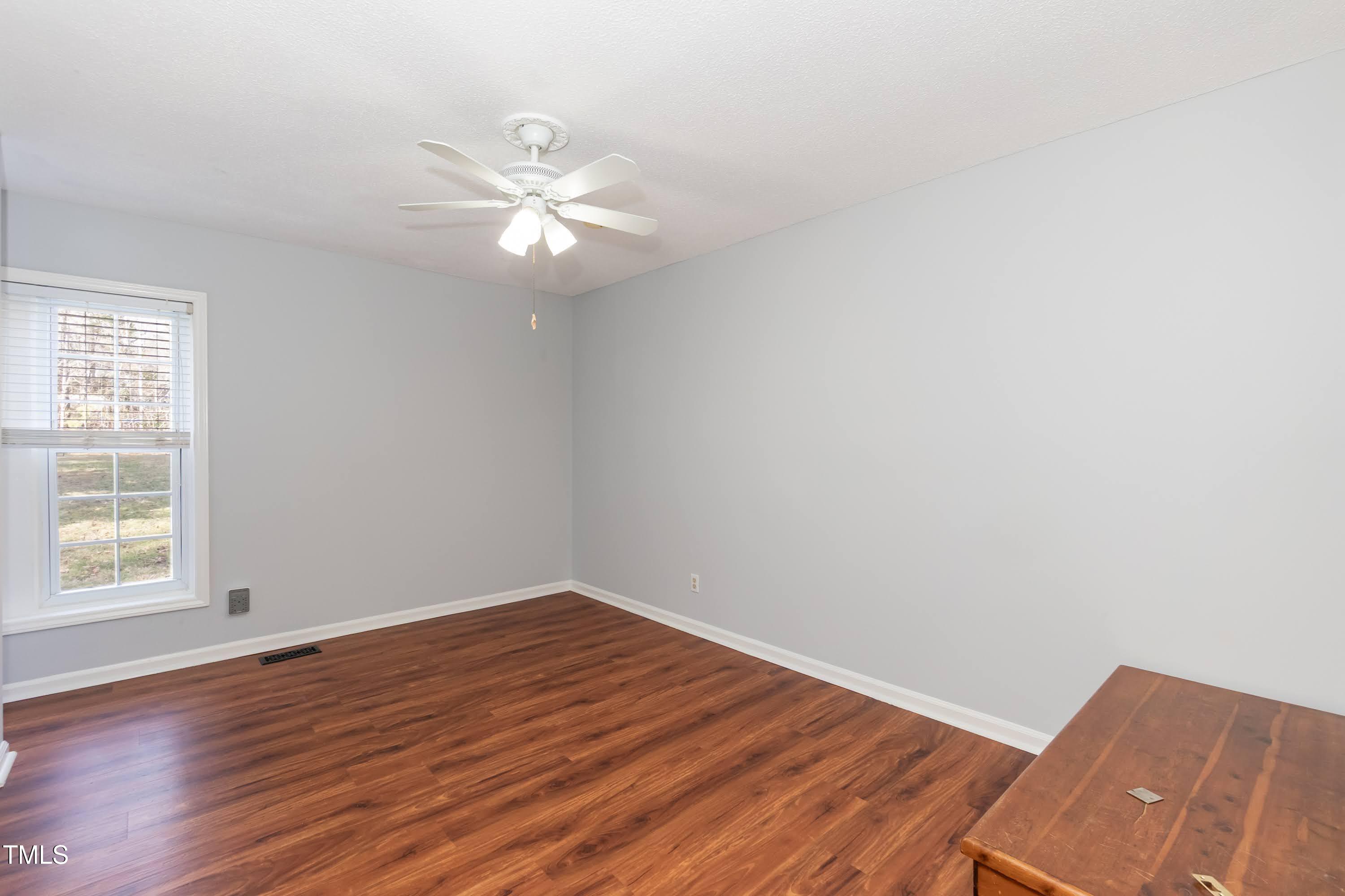 5604 Genesee Drive Durham, NC 27712 - Photo 27 of 45 an empty room with wooden floor fan and windows
