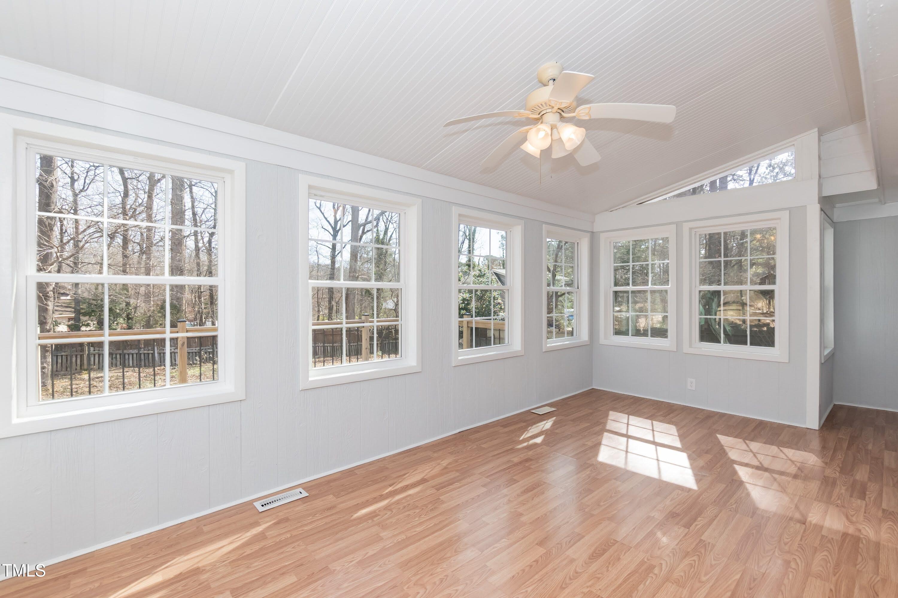 5604 Genesee Drive Durham, NC 27712 - Photo 32 of 45 a view of an empty room with wooden floor and a window