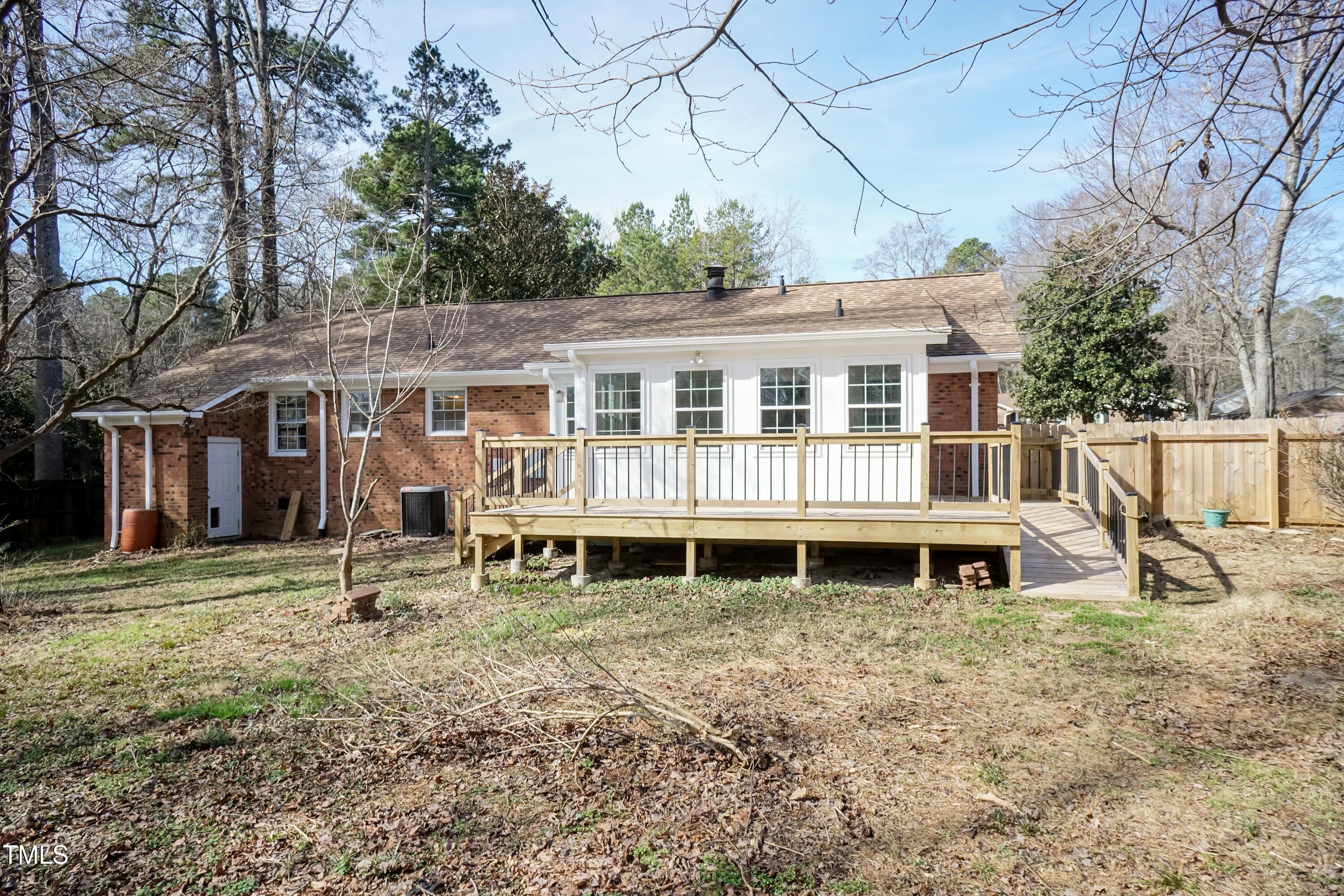 5604 Genesee Drive Durham, NC 27712 - Photo 40 of 45 a backyard of a house with wooden deck and outdoor seating