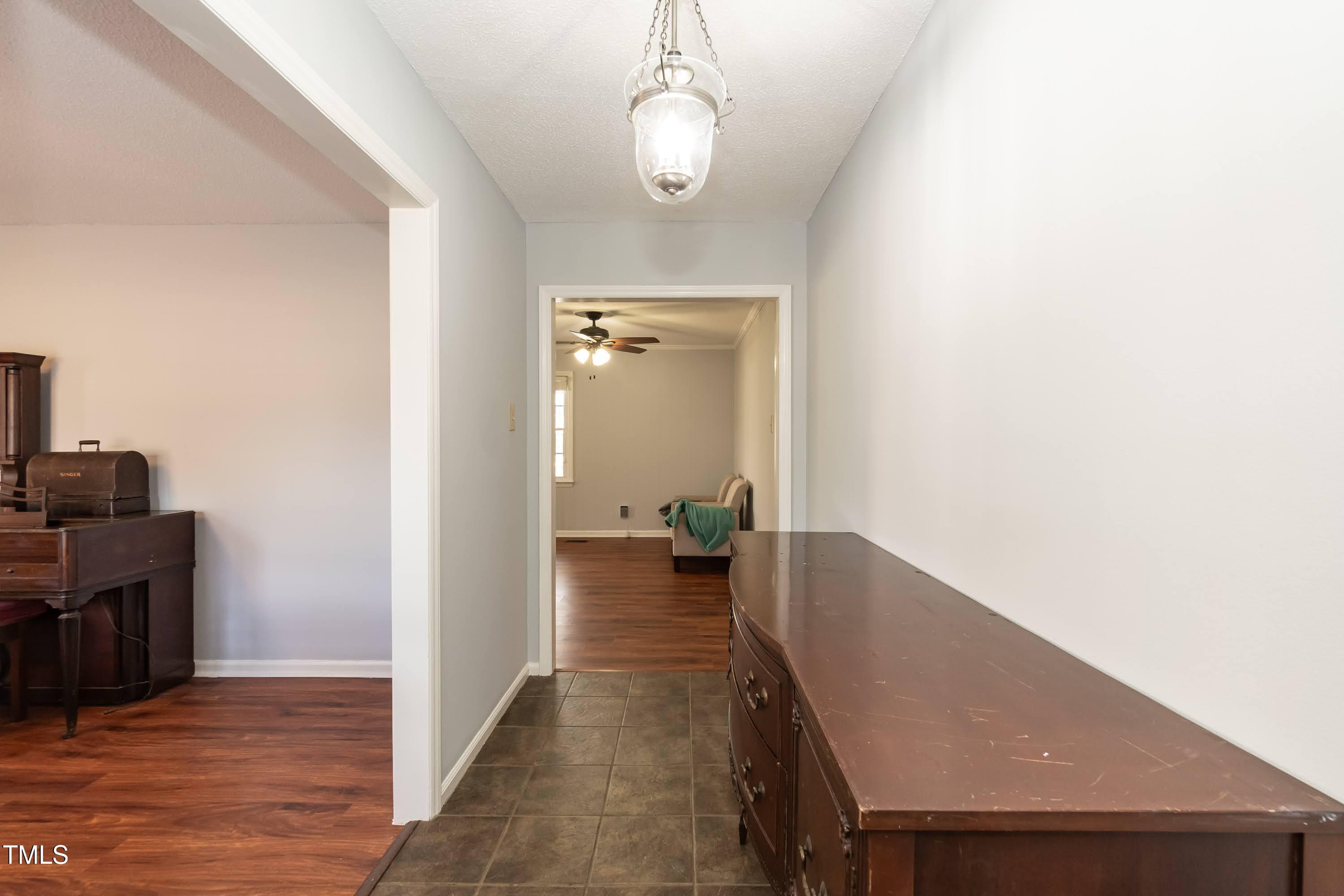 5604 Genesee Drive Durham, NC 27712 - Photo 5 of 45 a view of a hallway with wooden floor and furniture