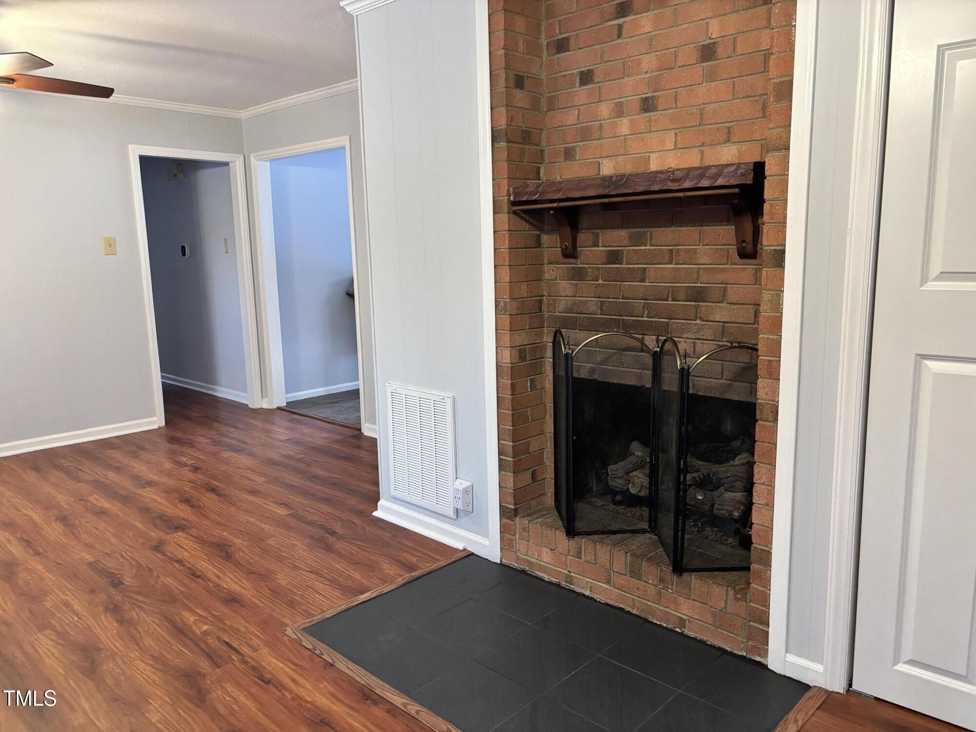 5604 Genesee Drive Durham, NC 27712 - Photo 8 of 45 a view of a livingroom with wooden floor and a fireplace