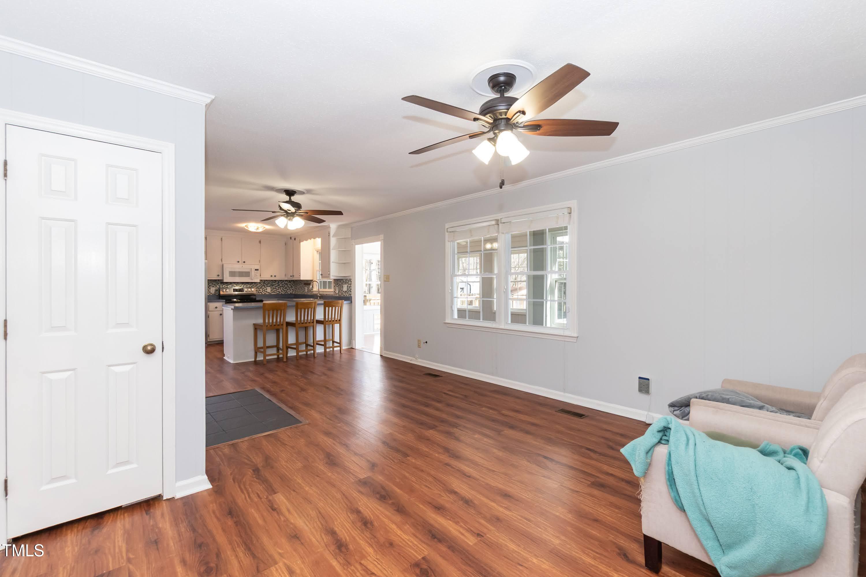 5604 Genesee Drive Durham, NC 27712 - Photo 9 of 45 a view of a livingroom with a hardwood floor and a ceiling fan