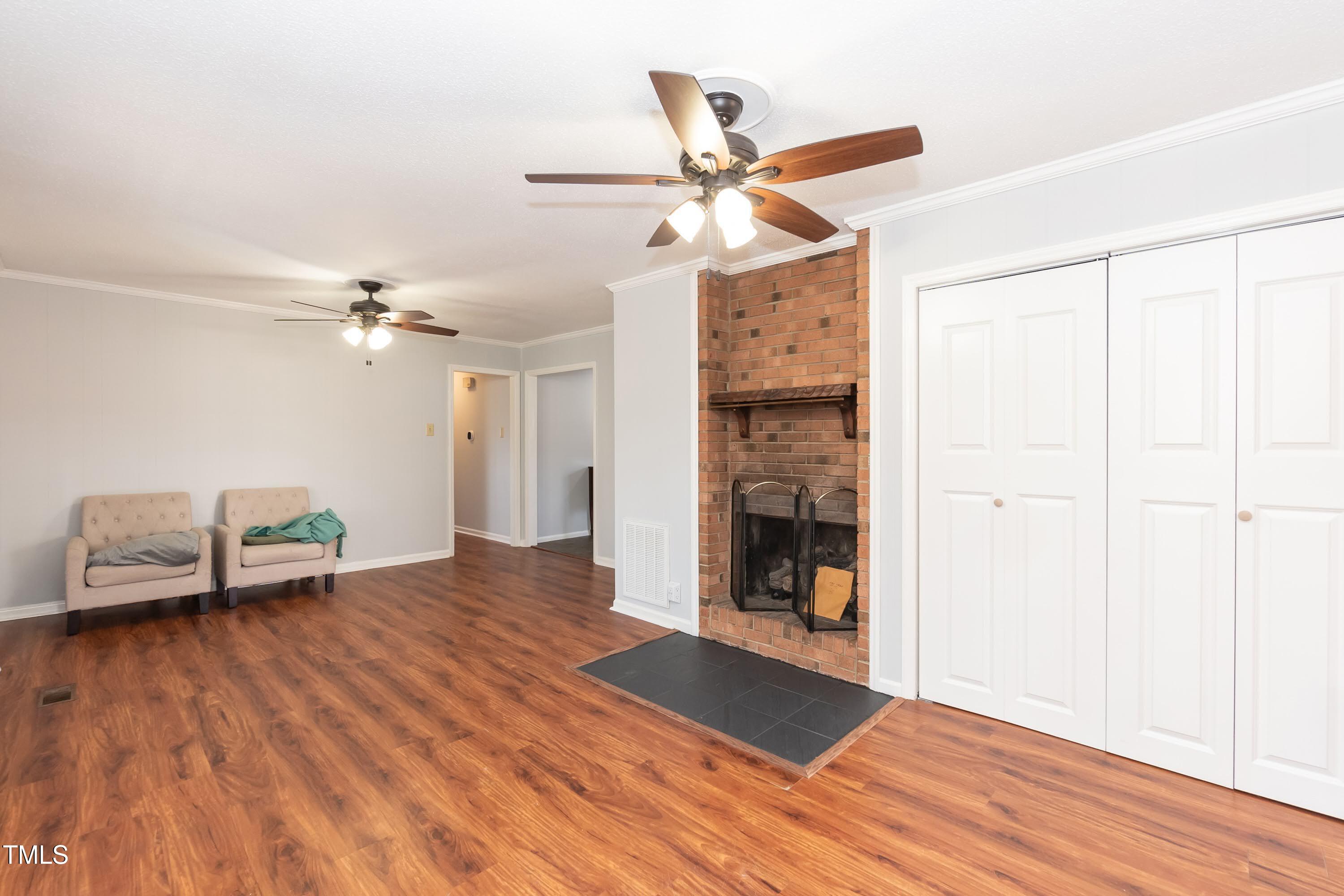 5604 Genesee Drive Durham, NC 27712 - Photo 10 of 45 a view of a livingroom with a ceiling fan and wooden floor