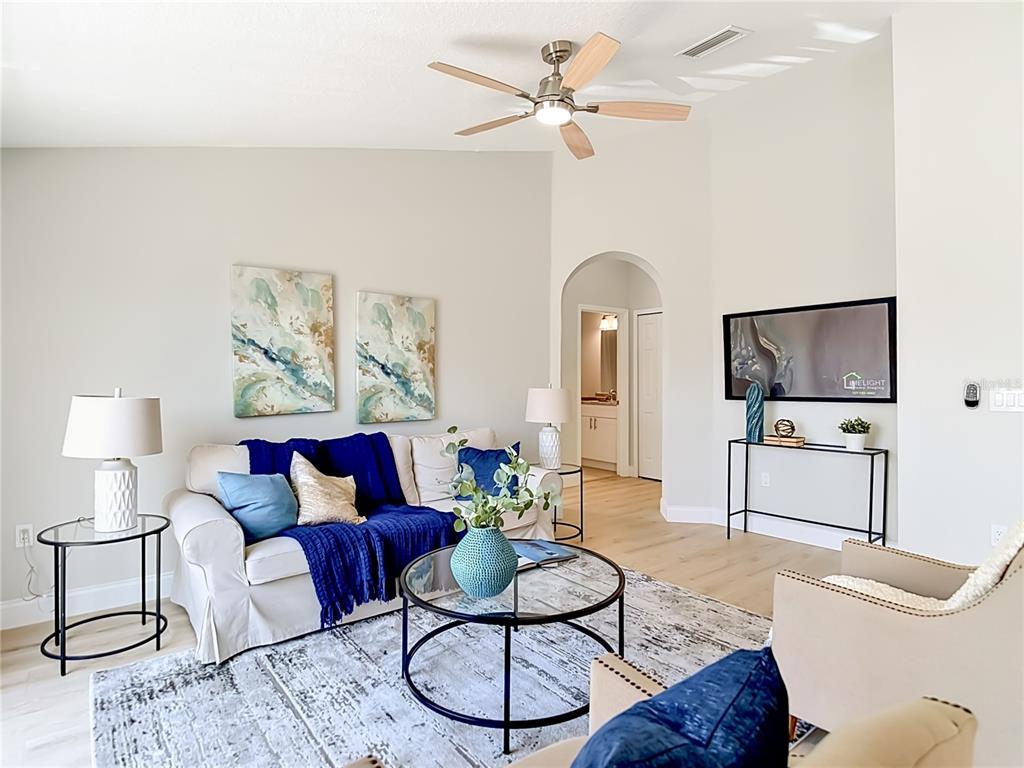 5310 Anhinga Trail New Port Richey, FL 34653 - Photo 3 of 27 a living room with furniture and a flat screen tv