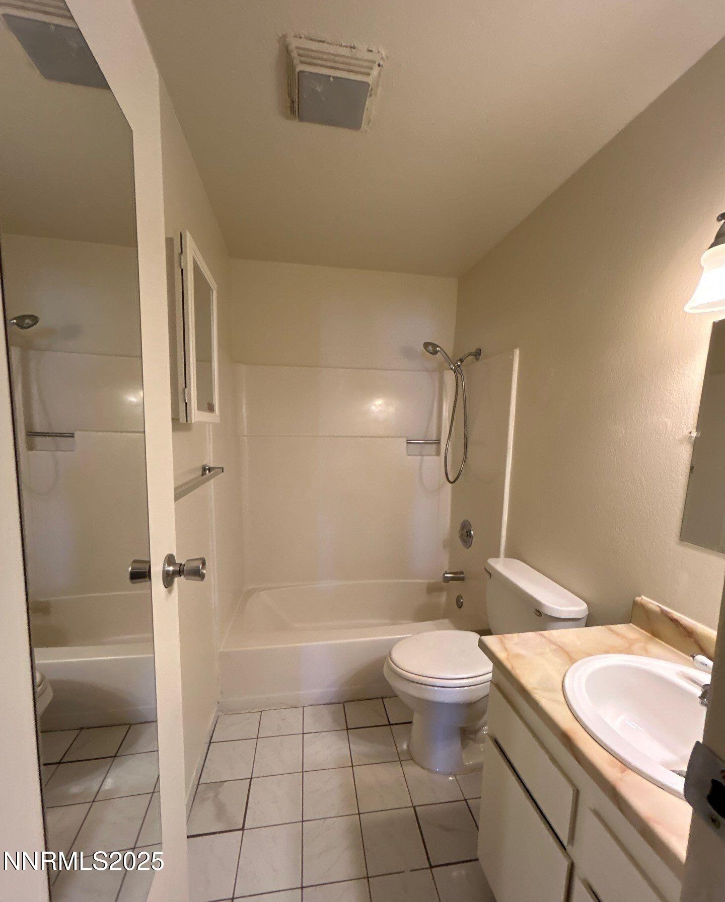 1410 East 9th Street, Unit 11 Reno, NV 89512 - Photo 5 of 5 a bathroom with a granite countertop sink toilet and shower