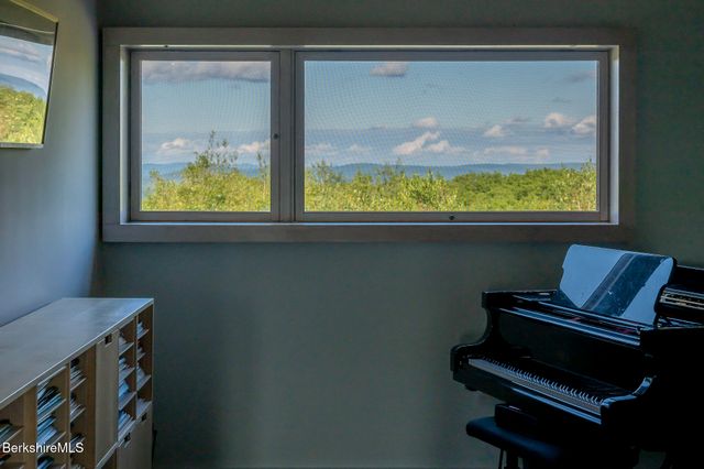 a view of an entryway with wooden floor and windows