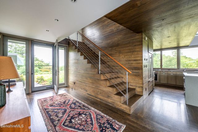 a bathroom with a toilet a sink and a large mirror