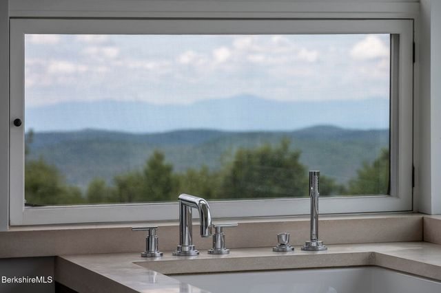 a room with a large window and a bed