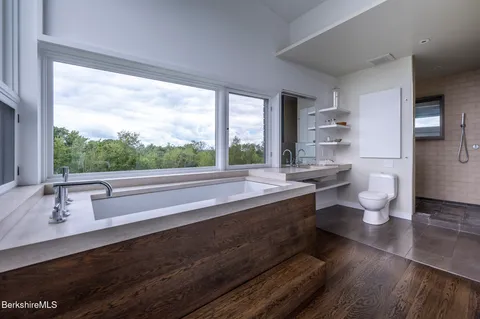 a view of a porch with furniture and a yard