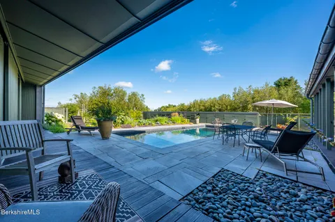 a view of house with swimming pool outdoor seating