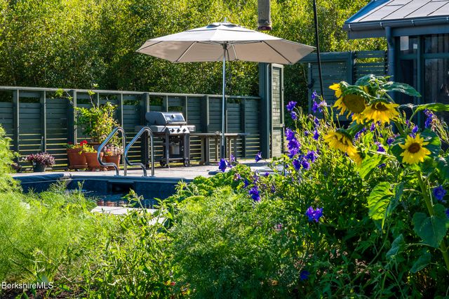 a view of a patio with a table and chairs and potted plants
