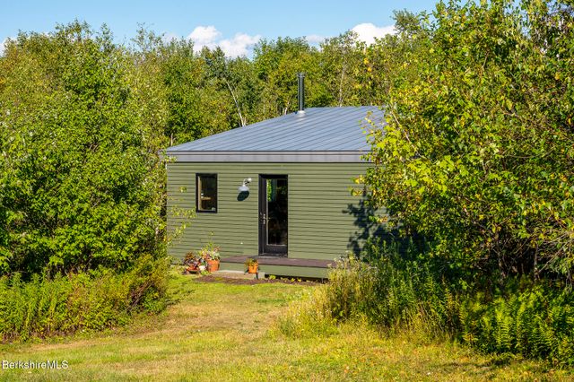 a dining room with wooden floor glass table and chairs