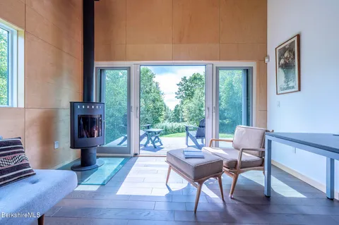 a bed sitting in a spacious bedroom next to a window