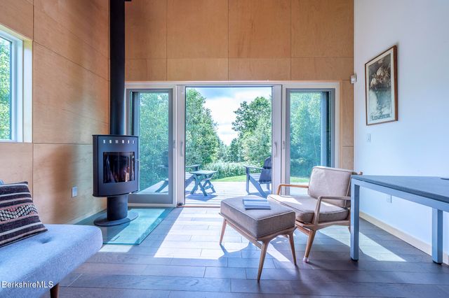 a bed sitting in a spacious bedroom next to a window