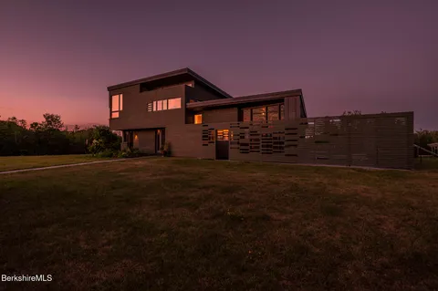 a view of house with yard and green space