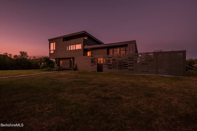 a view of house with yard and green space