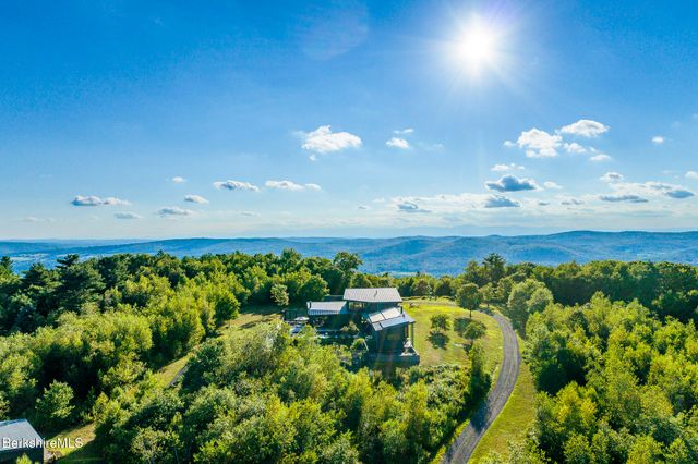 a backyard of a house with lots of green space and garden space