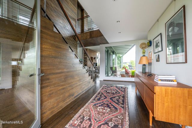 a large living room with a large window a table and chairs