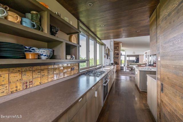 a kitchen with stainless steel appliances granite countertop a stove and cabinets