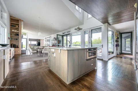 a dining room with furniture and wooden floor