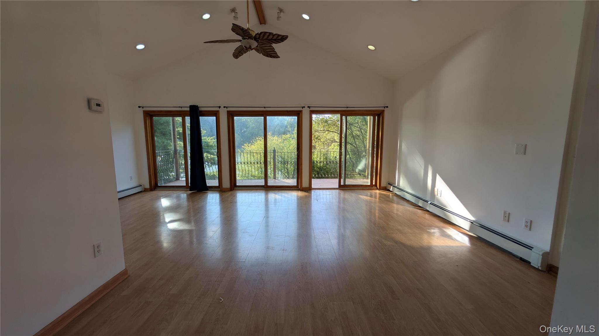 169 Shear Hill Road Mahopac, NY 10541 - Photo 6 of 31 Empty room featuring a baseboard heating unit, high vaulted ceiling, wood finished floors, ceiling fan, and recessed lighting