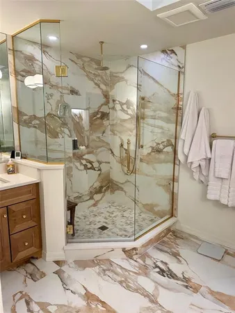 a bathroom with a shower sink and mirror
