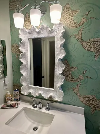 a bedroom with a bed and a lamp on dresser