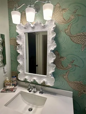 a bedroom with a bed and a lamp on dresser