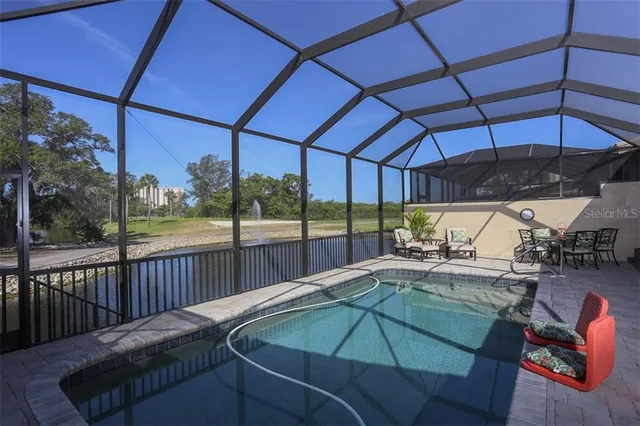 a view of a patio with a table and chairs under an umbrella