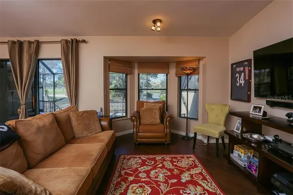 a living room with furniture fireplace and flat screen tv
