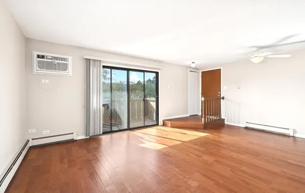 a view of an empty room with glass door
