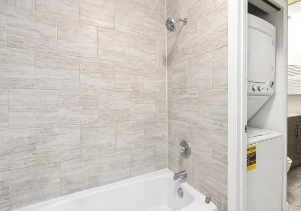 a bathroom with a bathtub and a shower