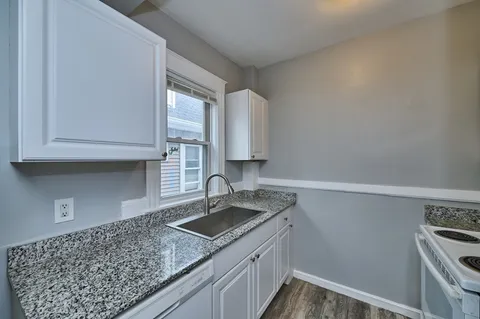 a kitchen with a sink and cabinets