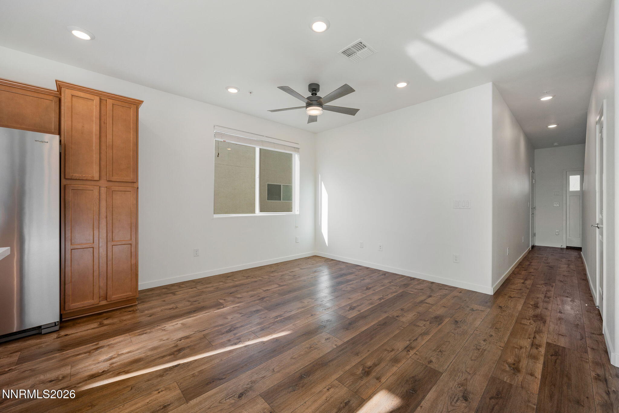 530 Gloria May Lane Reno, NV 89503 - Photo 11 of 34 an empty room with wooden floor and a ceiling fan