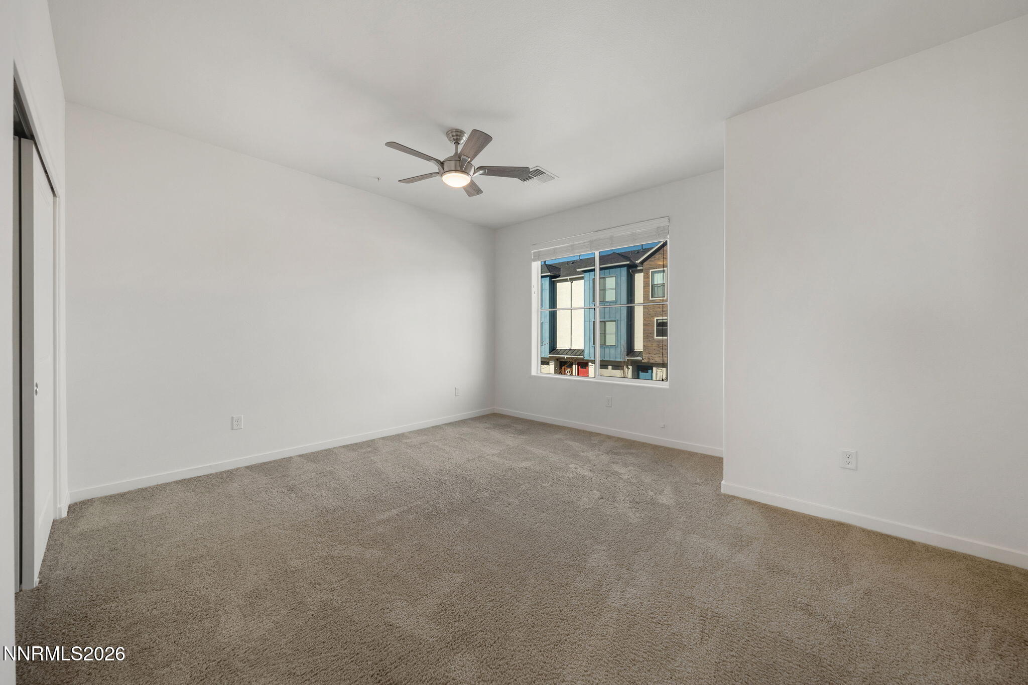 530 Gloria May Lane Reno, NV 89503 - Photo 15 of 34 an empty room with a window and a ceiling fan