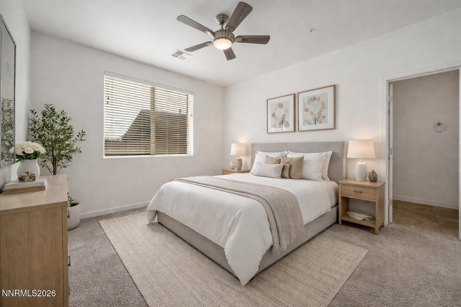 530 Gloria May Lane Reno, NV 89503 - Photo 18 of 34 a bedroom with a large bed and a chandelier fan