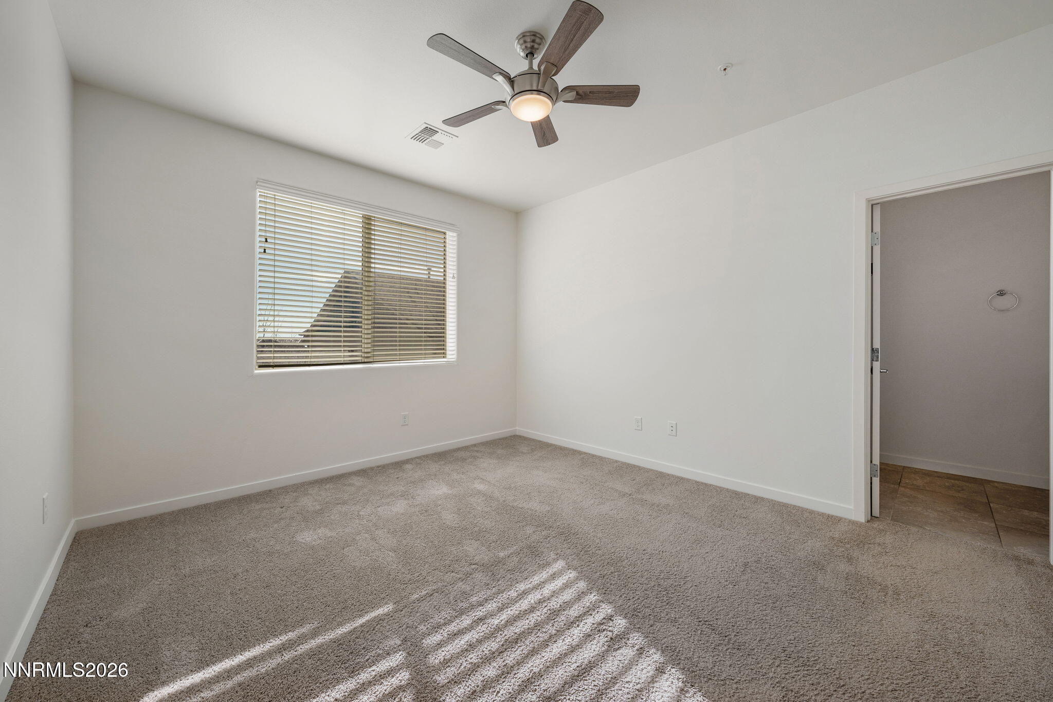 530 Gloria May Lane Reno, NV 89503 - Photo 19 of 34 an empty room with windows and fan