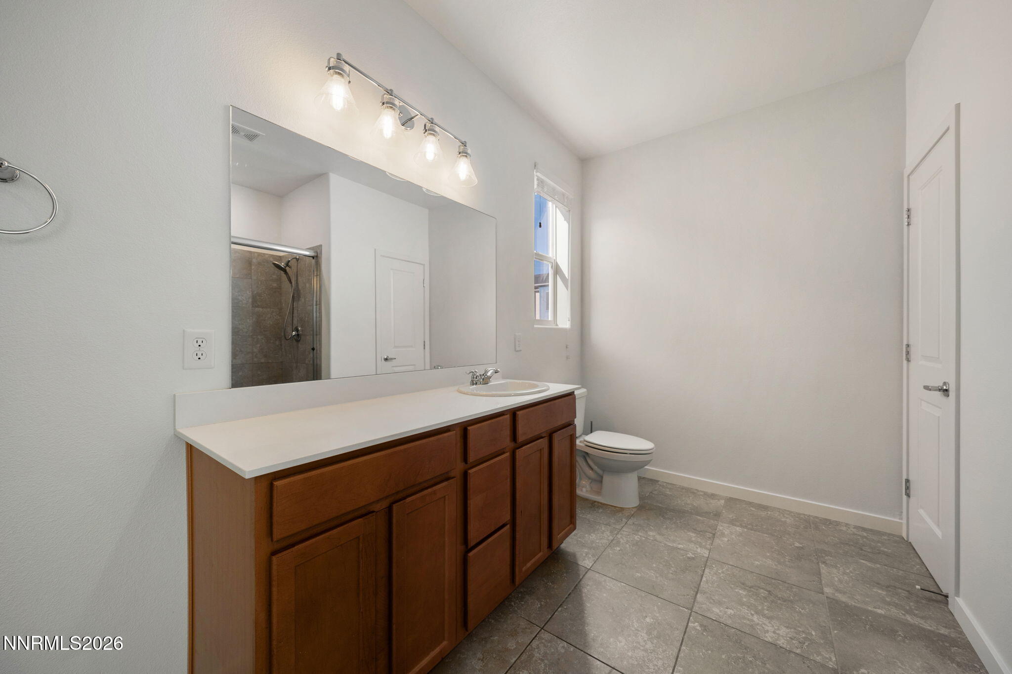 530 Gloria May Lane Reno, NV 89503 - Photo 22 of 34 a bathroom with a granite countertop sink a toilet and a mirror