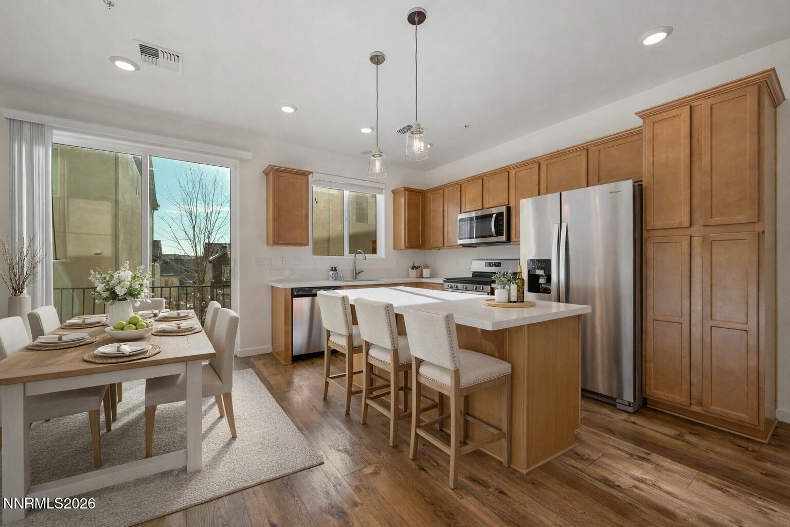 530 Gloria May Lane Reno, NV 89503 - Photo 3 of 34 a kitchen with stainless steel appliances granite countertop a refrigerator a stove top oven a sink dishwasher and white cabinets with wooden floor