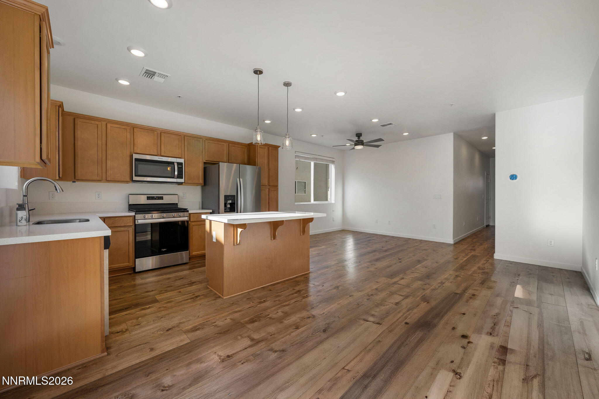 530 Gloria May Lane Reno, NV 89503 - Photo 7 of 34 a large kitchen with stainless steel appliances kitchen island a large counter top and a stove top oven