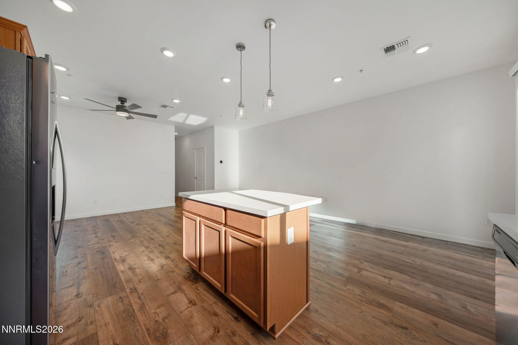530 Gloria May Lane Reno, NV 89503 - Photo 10 of 34 a kitchen with a refrigerator and a wooden floor