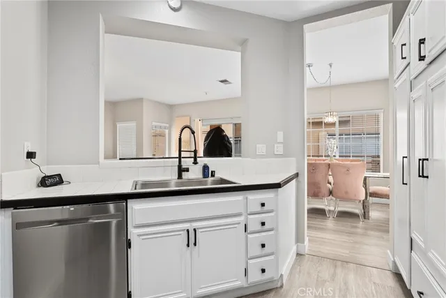 a close view of a sink and a large mirror in a room