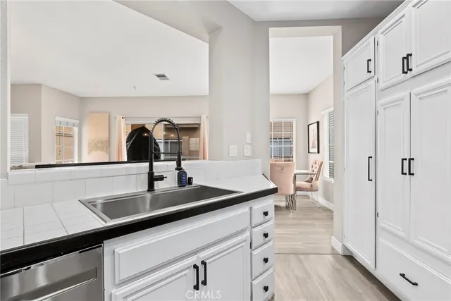 a kitchen with a sink and refrigerator