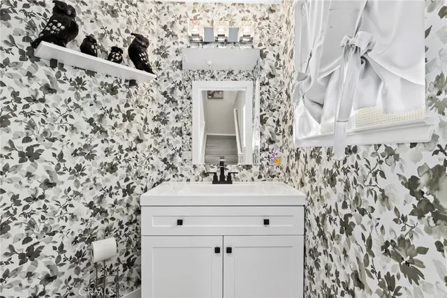 wooden bathroom with a sink and a mirror