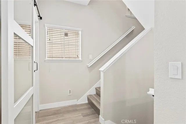 a view of entryway and hall with wooden floor