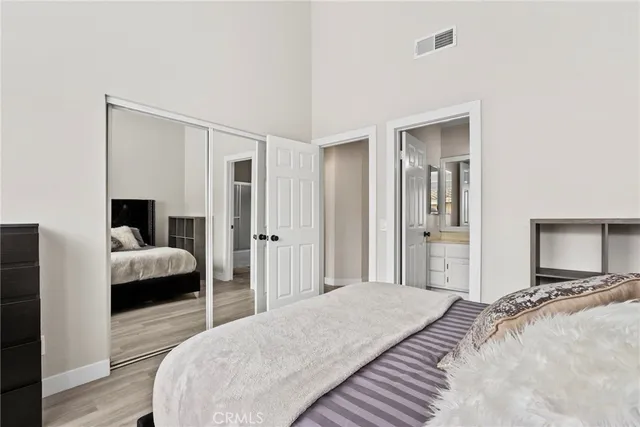 a bedroom with a bed and a large mirror