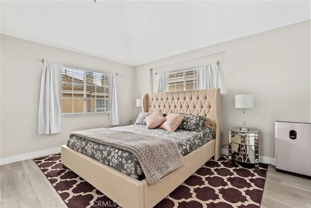 a bedroom with a bed and a refrigerator