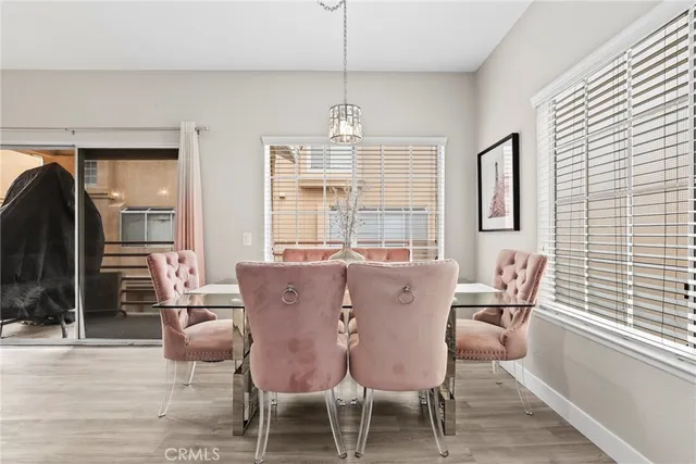 a dining room with furniture window and wooden floor